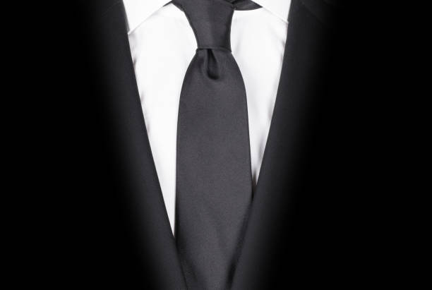 istock Man in a black suit with black tie, close-up 1254505540