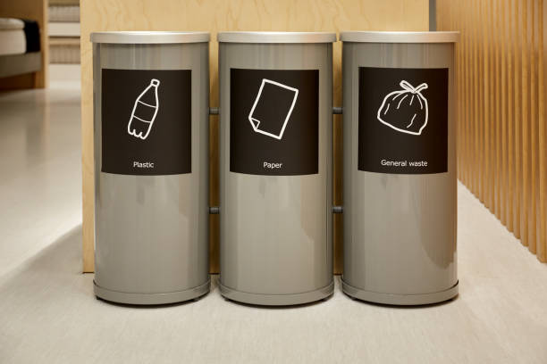 Recycle bins with icon inside shopping mall.