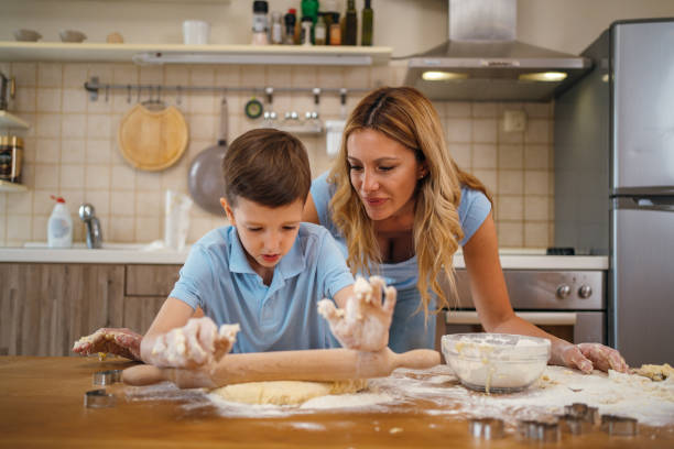 istock Mother and son having fun with dough 1254511520