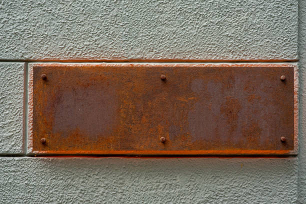 Old rusty metal sign on the wall.