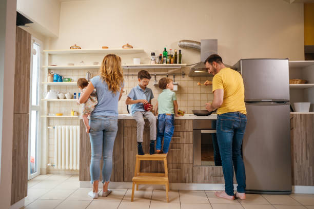 istock Family cooking a meal together 1254512809