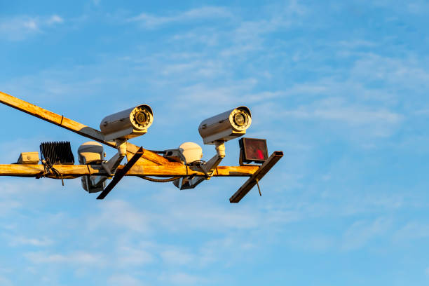 istock Radar speed control camera on the road on blue sky background. 1254513872