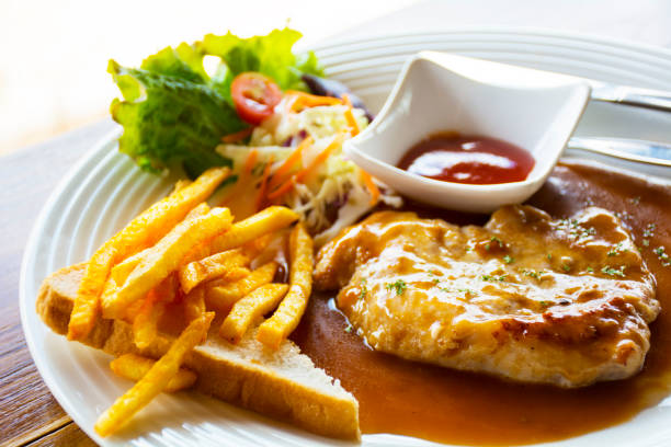 juicy grilled pork chop (neck cut) with greens