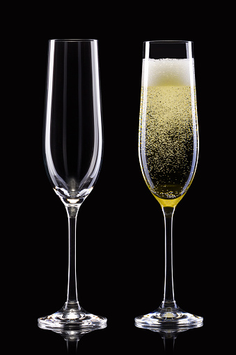 Two glasses of Champagne with a cork.