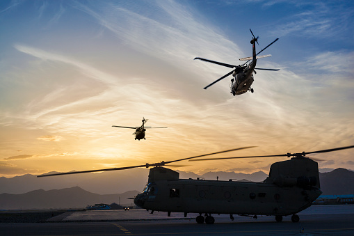 Military helicopters on Airbase at sunset