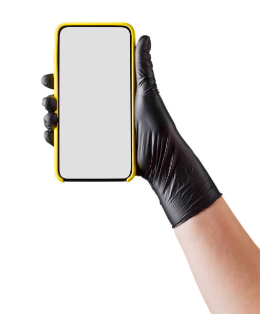 istock Hand in black glove holding mobile phone with blank screen isolated on white 1254516803