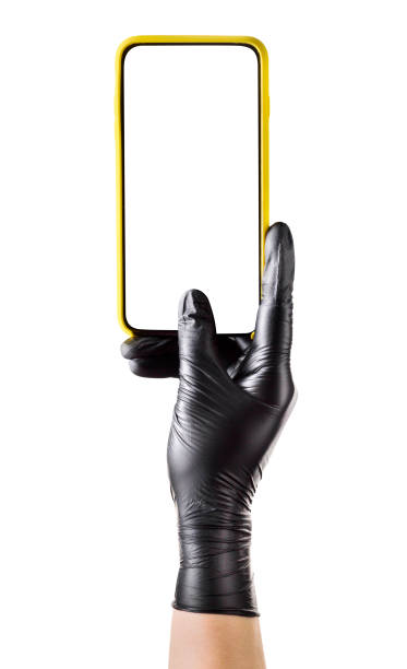 istock Hand in black glove holding mobile phone with blank screen isolated on white 1254516852