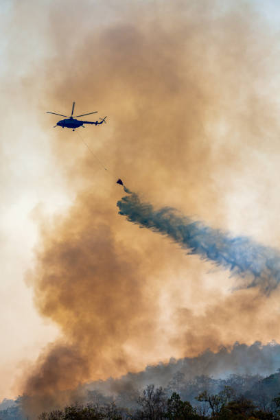istock Firefithing helicopter dumps water on forest fire 1254519451