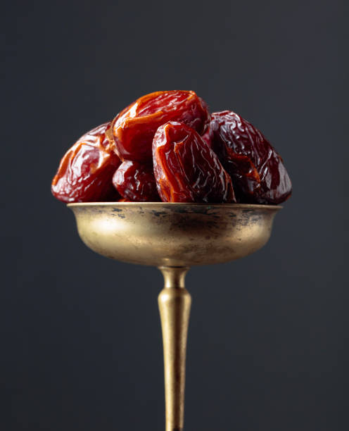 istock Closeup sweet dried dates in brass dish. 1254520805