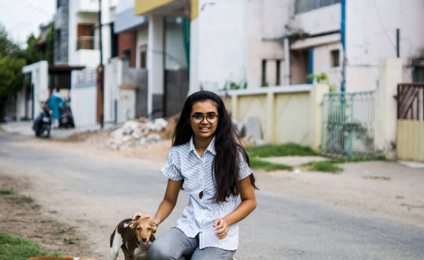 istock girl playing with puppies 1254525075