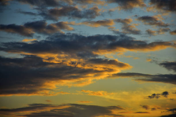 istock Beautiful dramatic puffy clouds at sunset against blue skies. 1254525843