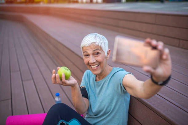 istock Female jogger exercising outdoors and taking photographs. 1254527063