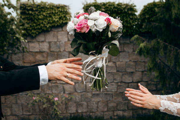 istock Wedding bouquet flying to hands on green background 1254528452
