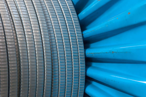 istock Cable factory. Large metallic bobbins with cable in the workshop 1254528798