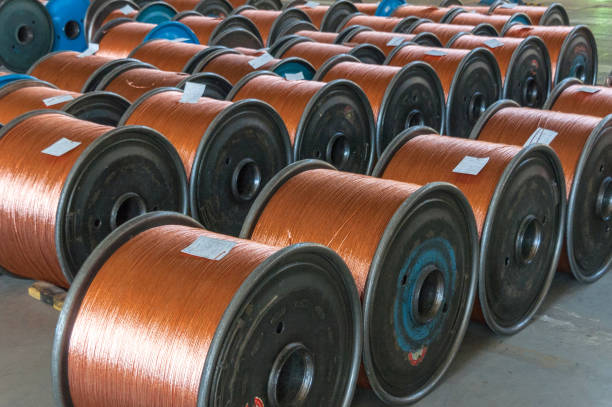 Coils of shiny copper on shelf in close up view
