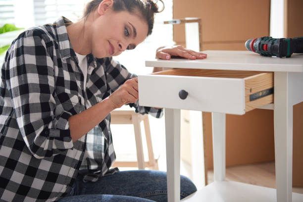 istock Young woman renovating a night table 1254529189