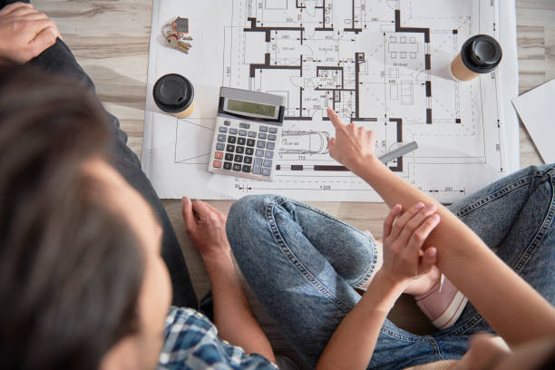 istock Top view of blueprint discussed by a couple 1254529225