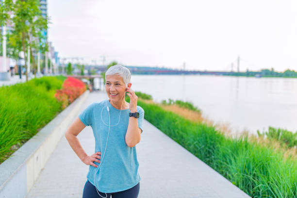 istock Athletic mature woman resting after jogging. 1254529281