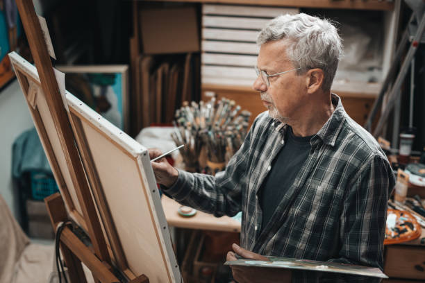 istock Senior artist painting in his studio 1254529345