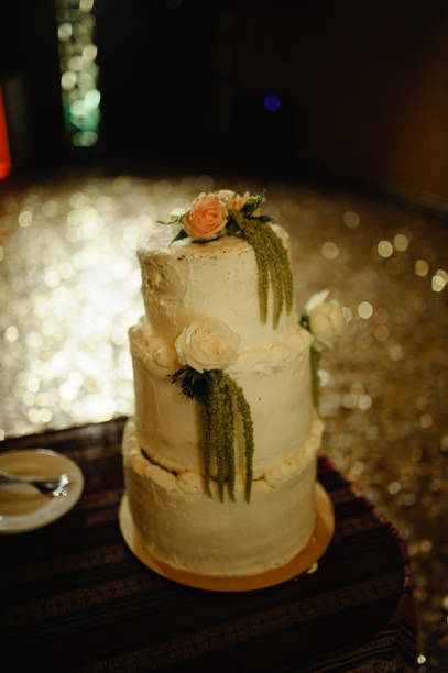 istock Wedding cake on a background of a dark wedding hall. 1254529432