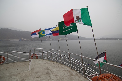 Gangwon-do, South Korea - 15 February 2019: Flying flags at the front of ferry.