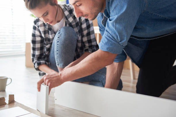 istock Serious couple installing new furnitures 1254530495