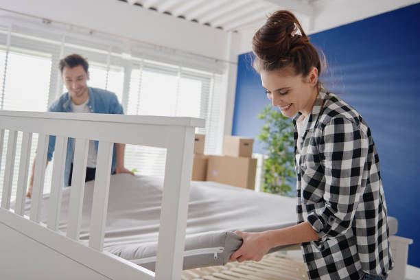 istock Couple putting mattress on the bed 1254532309