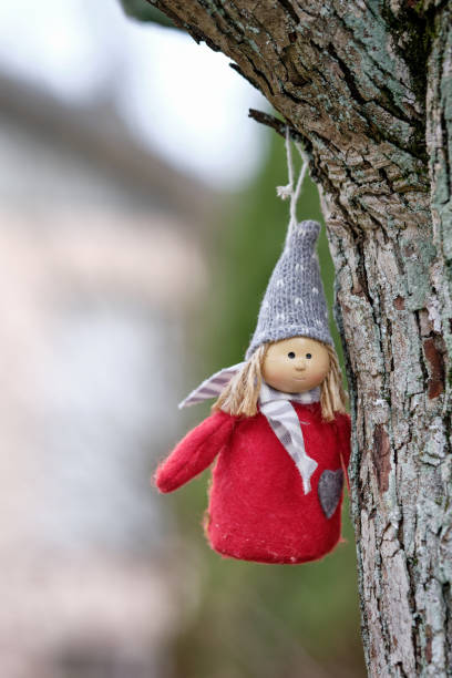istock Little cute red puppet hanging on a tree 1254532831