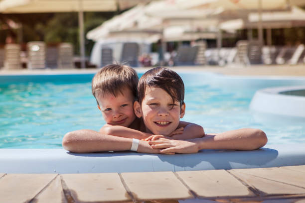 istock Two brothers near the pool on a summer day 1254536888