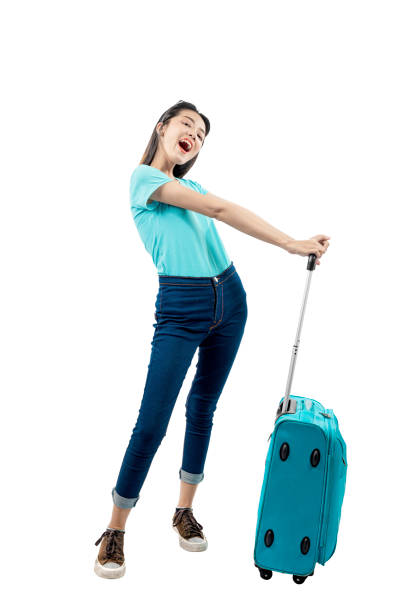 istock Asian woman standing with suitcase 1254538073