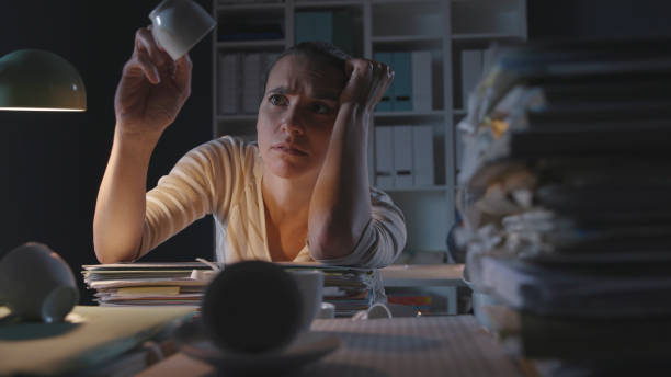 istock Frustrated woman working in the office at night 1254539221