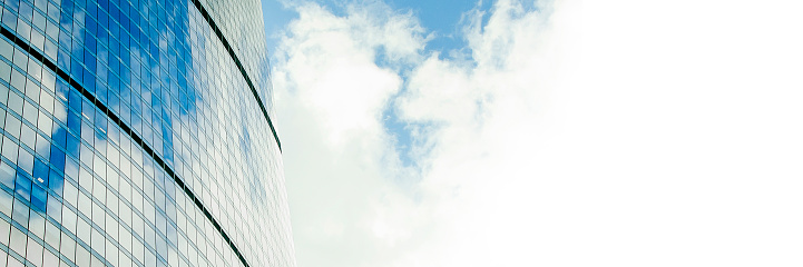 Fragment of a beautiful modern building against the sky. Panoramic banner with place for text, copy space.