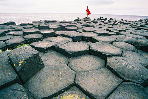The Giant’s Causeway interlocking basalt columns natural beauty with a man with a Masai Blanket standing