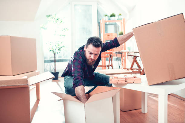 istock Handsome Male Spending His Time To Pack Before Moving 1254540931