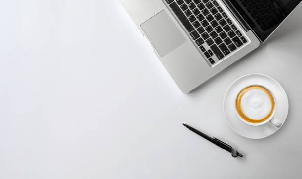 istock top view of office desk workspace with coffee cup, keyboard and work schedule on white table background. flat lay 1254541052