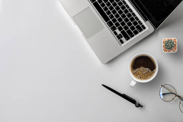 istock top view of office desk workspace with coffee cup, keyboard and work schedule on white table background. flat lay 1254541054