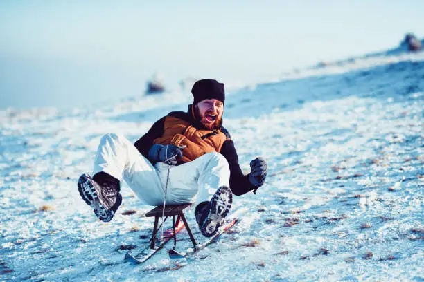 Funny Male Experiencing Sledding Adrenaline