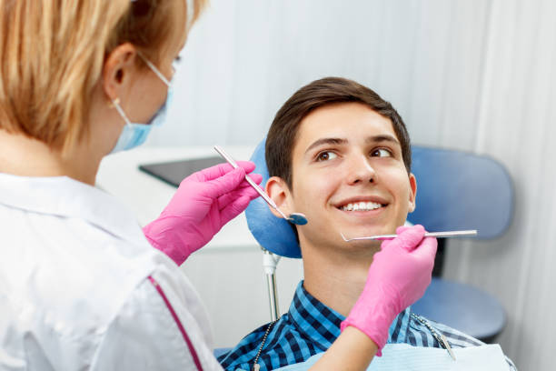 istock Handsome young man is having dental check up in dental office 1254542638