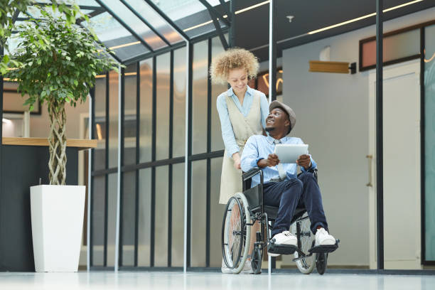 istock Woman with disabled man 1254542713