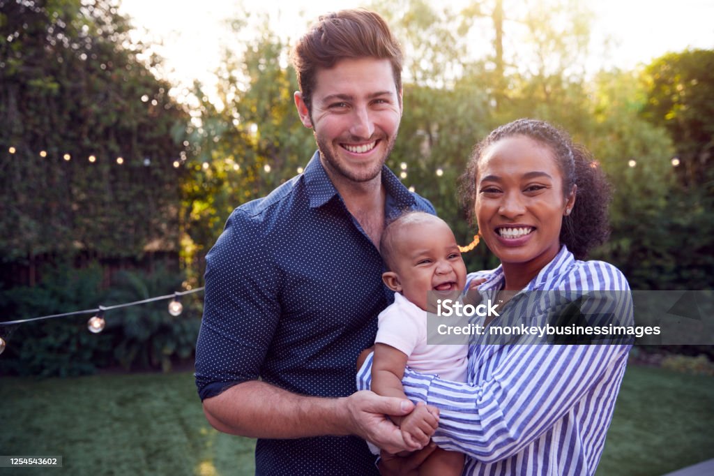 Portrait Of Family With Baby Son At Home Outdoors In Garden Family Stock Photo