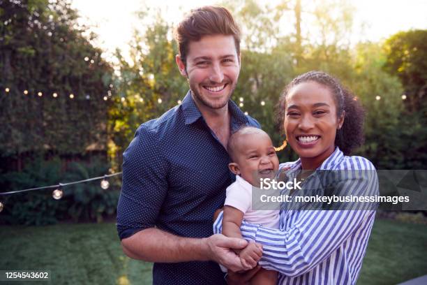 Portrait Of Family With Baby Son At Home Outdoors In Garden Stock Photo - Download Image Now