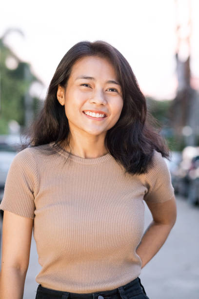 istock Happy smiling young thai woman in sunset 1254543929