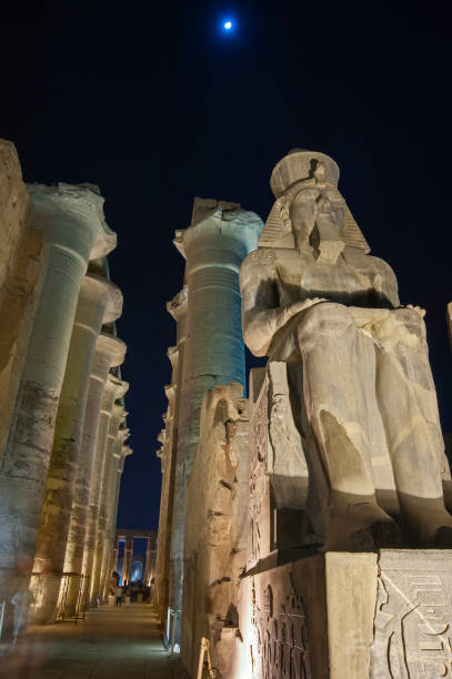 istock Statues and columns in hypostyle hall at Luxor Temple during night 1254545199
