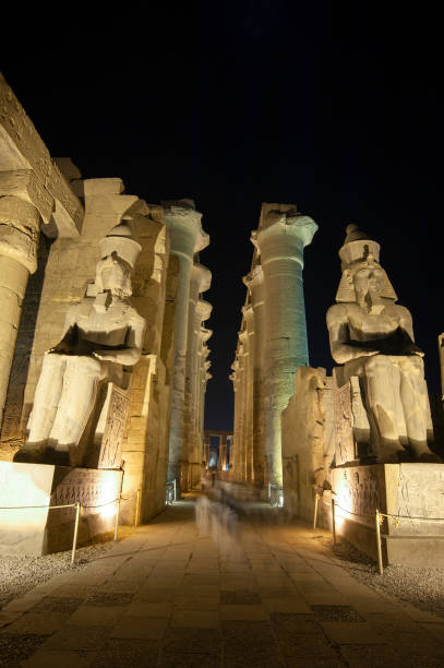 istock Statues and columns in hypostyle hall at Luxor Temple during night 1254545250