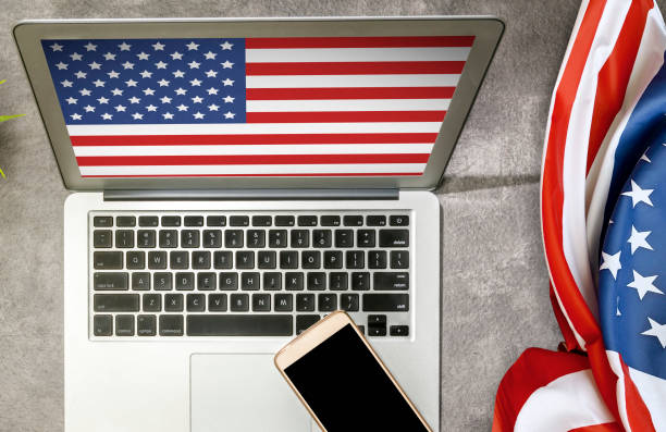istock American flag on the desk and laptop screen 1254548795