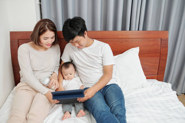 istock Parents and baby watching cartoon 1254549316