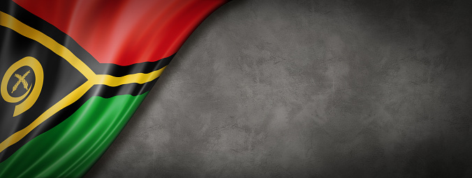 Vanuatu flag on concrete wall. Horizontal panoramic banner.
