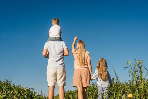 istock Happy family in field. Back view. 1254549937