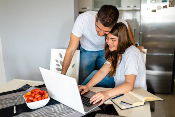 istock Joyful young couple making a online reservation for their next summer vacation 1254549984