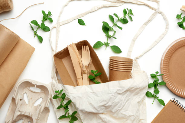 istock textile bag and disposable tableware from brown craft paper, green mint leaves 1254550212